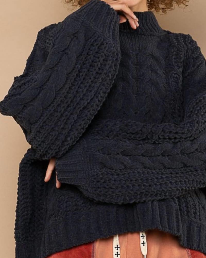 Front of a model wearing a size Large Cozy Luxurious Cable Sweater in Black in Black by POL. | dia_product_style_image_id:327421